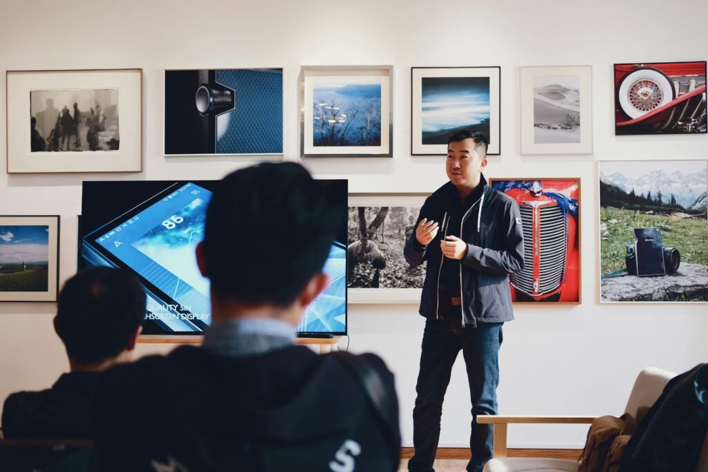 pexels photo 716276 716276 Man giving a presentation in a modern art gallery setting, engaging audience.